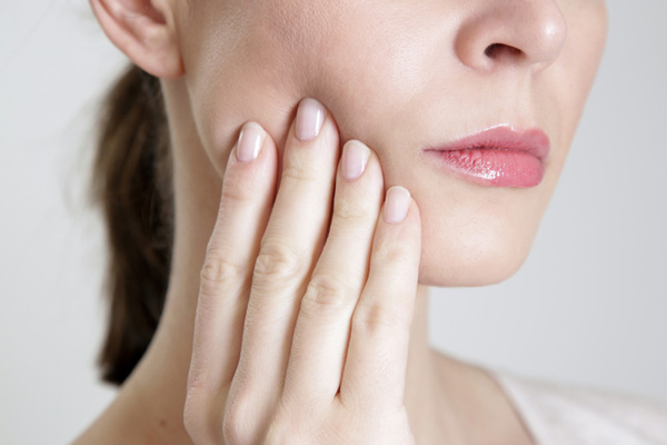 Close up of a woman with facial pain at Placentia Oral Surgery in Placentia, CA