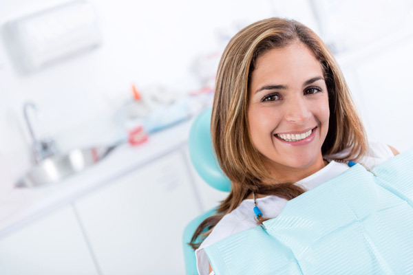 Smiling woman with mini dental implants from Placentia Oral Surgery in Placentia, CA