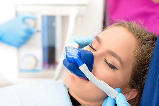 Woman with sedation mask on